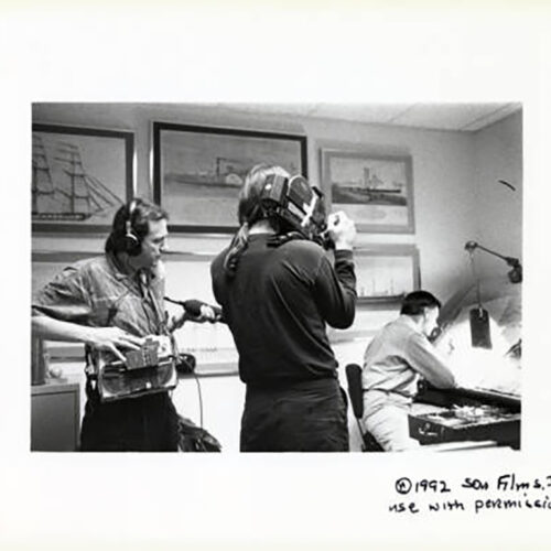 Director Mel Kiser and cameraman Barry Shea film editorial cartoonist Don Wright as he draws his final cartoon for the last issue of the Miami News.