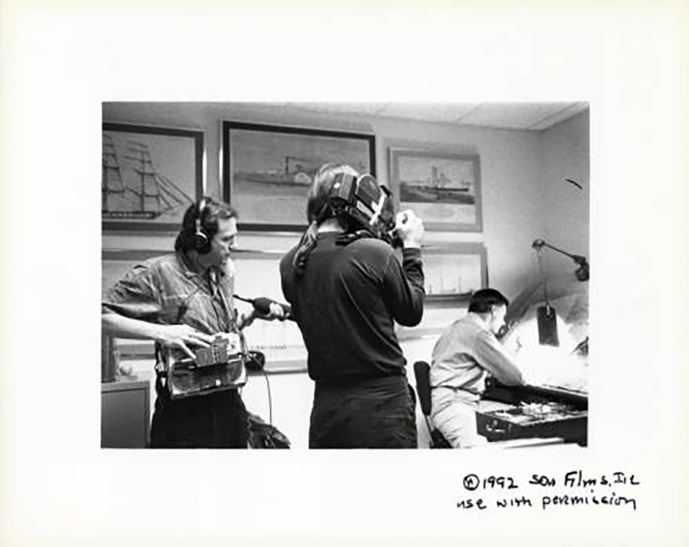 Director Mel Kiser and cameraman Barry Shea film editorial cartoonist Don Wright as he draws his final cartoon for the last issue of the Miami News.